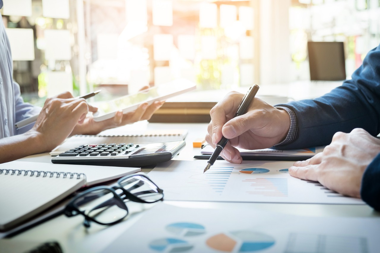 business man financial inspector and secretary making report calculating or checking balance. Internal Revenue Service inspector checking document. Audit concept